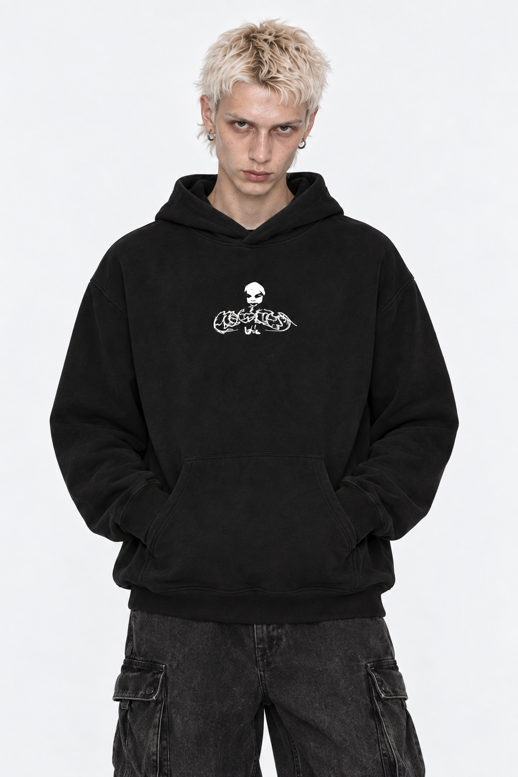 Model in the black fleece hoodie with the white Flawless skull logo, hood down, front view.