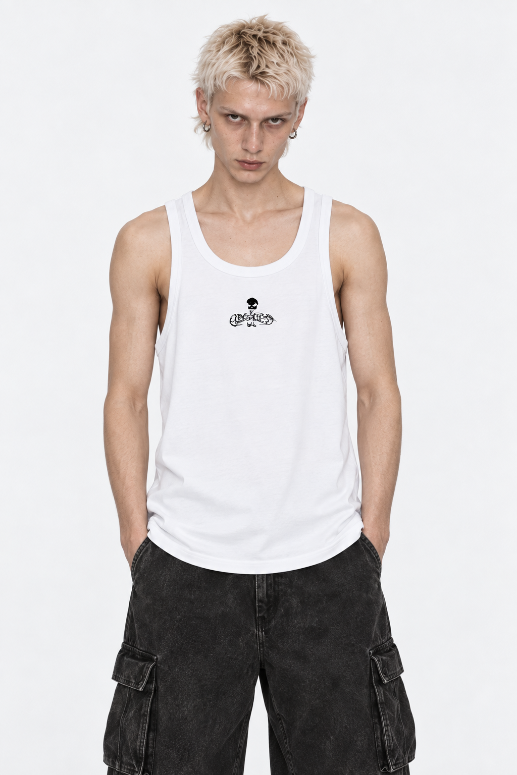 Model in the white ribbed tank top with the small black Flawless skull logo, front view.